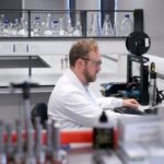 scientist in laboratory working on computer