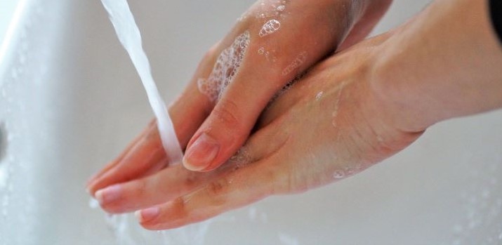 washing hands with soap under running water