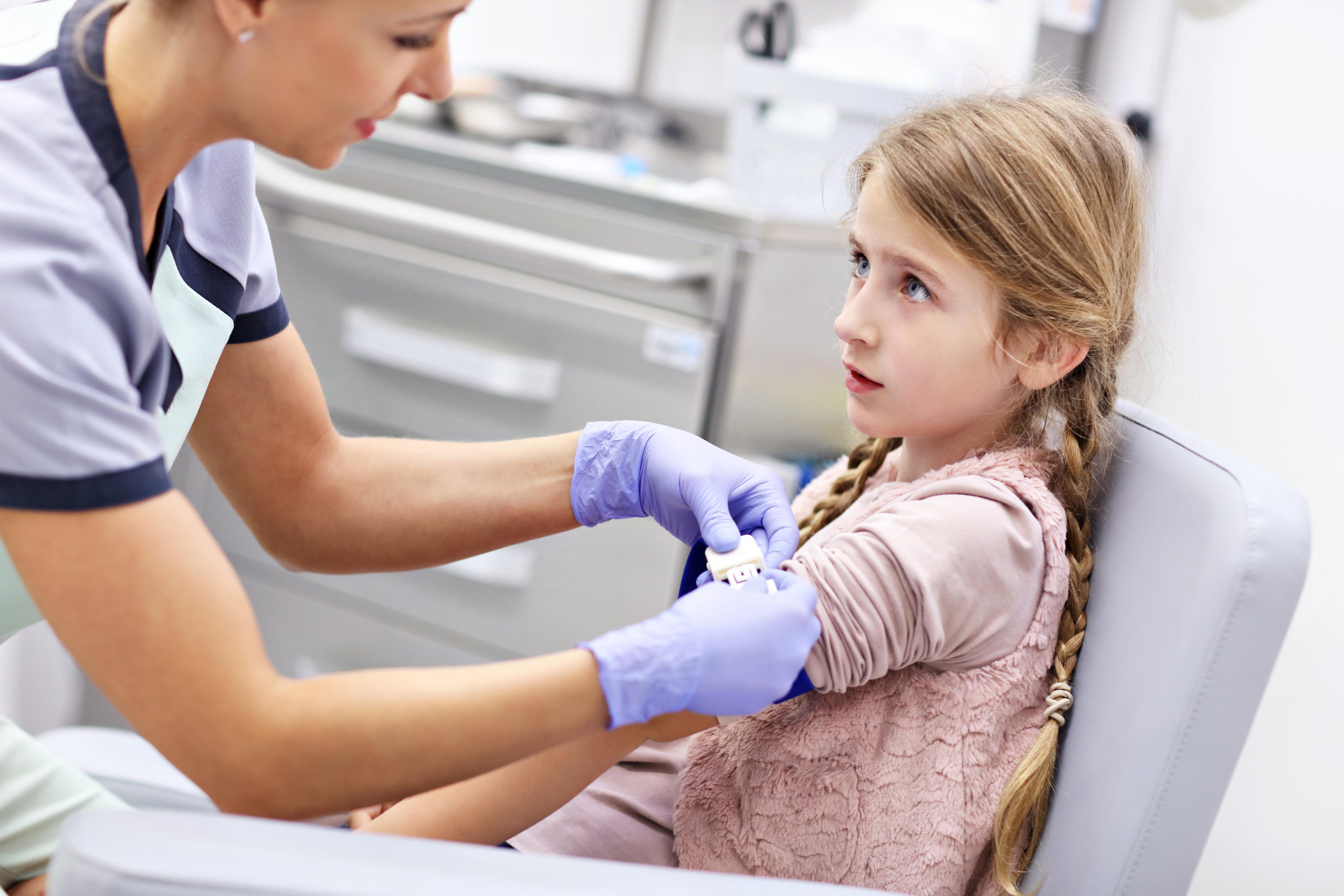 Brave little girl having blood collection for tests
