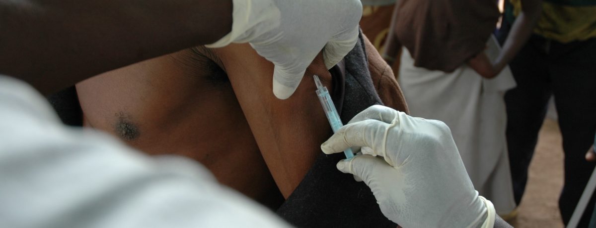 african man receives vaccine
