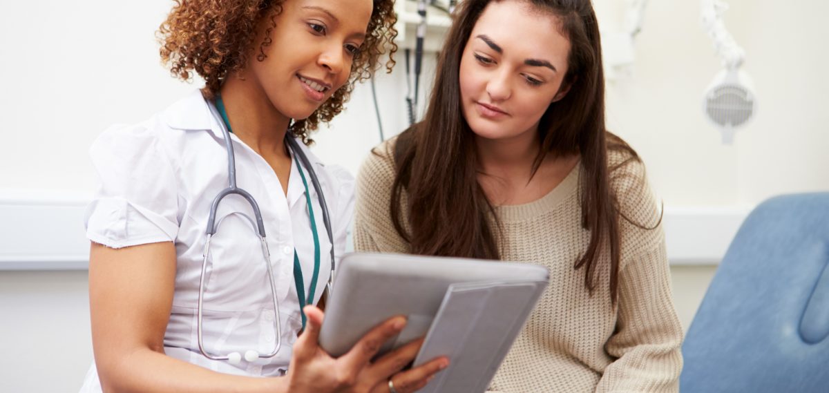 Doctor Showing Patient Test Results On Digital Tablet stock photo